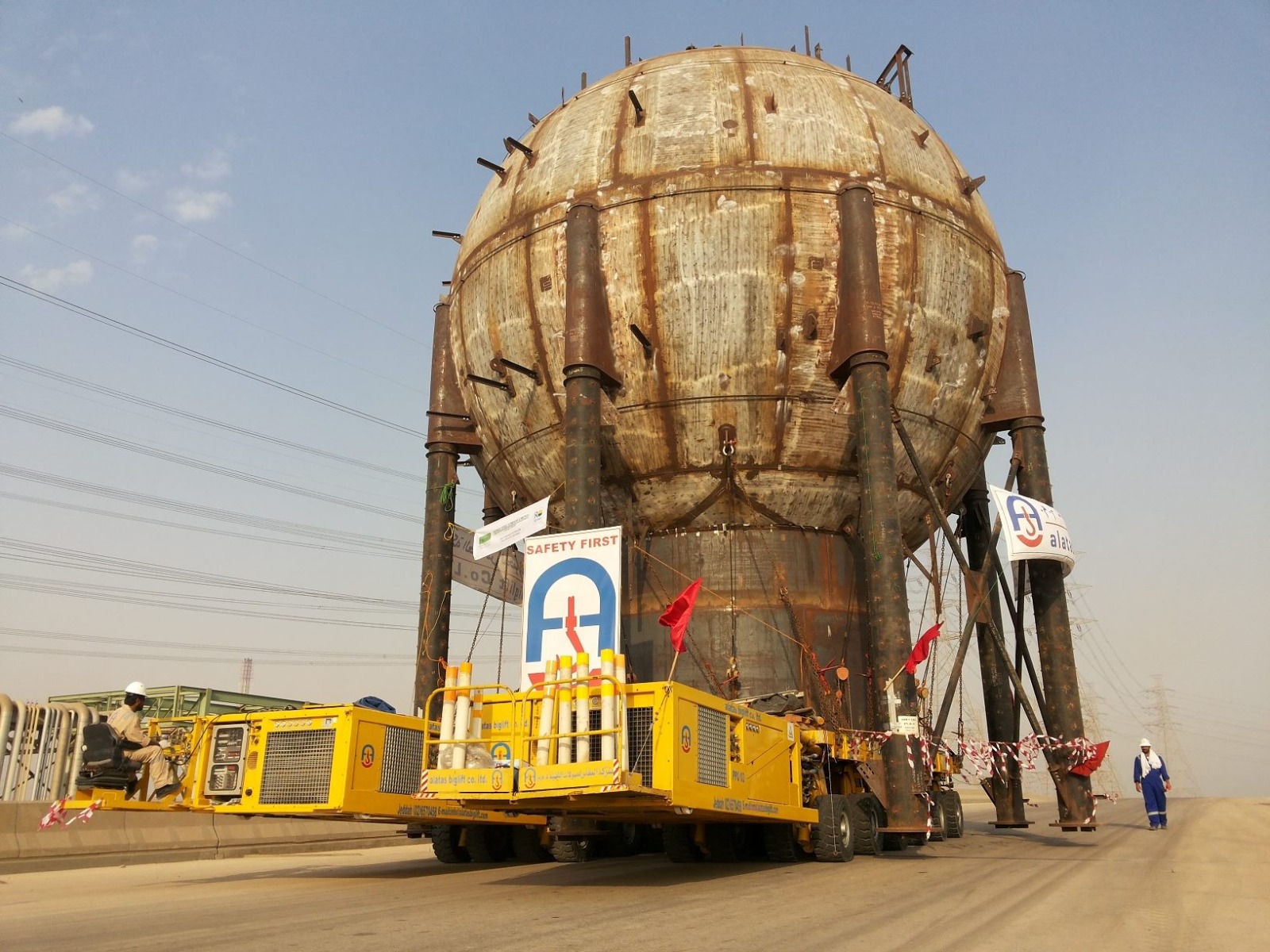 Self-propelled modular transporter moving a large spherical vessel — heavy haulage transport engineering